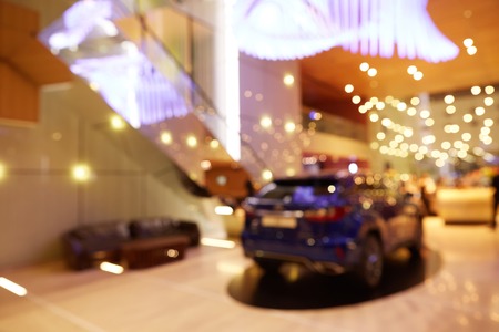 Blurred, defocused background of public event exhibition hall showing cars and automobilesの写真素材