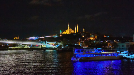 Night shot of Golden Horn Metro Bridge or Halic Bridge overlapping Suleymaniye Mosque, Istanbul, Turkey.の写真素材