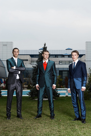 Three businessmen on megalopolis backgroundの写真素材