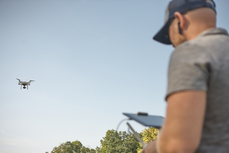 Man manages quadrocopters. Remote control for the drone in the hands of men. Unmanned aerial vehicle