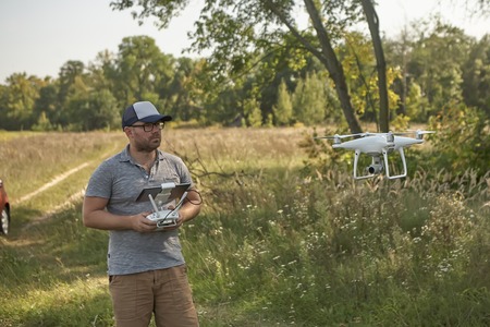 Man manages quadrocopters. Remote control for the drone in the hands of men. Unmanned aerial vehicle