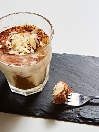 Tiramisu in glass, traditional coffee flavored Italian dessert made of ladyfingers and mascarpone.の写真素材