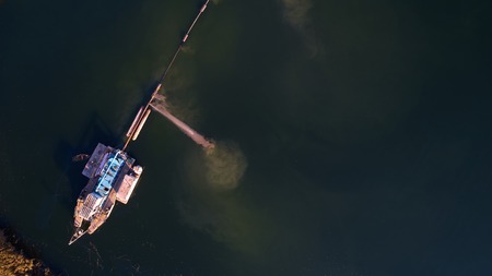 On the river there are works on extraction of sand. Works dredgeの写真素材