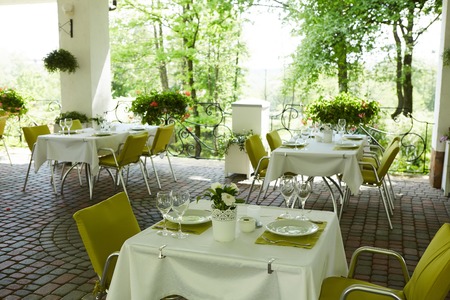 terrace summer cafe with tables and chairs for people, an empty institution for recreation, nobodyの写真素材