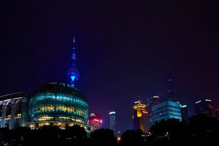 Shanghai, China - March 12, 2016: Oriental Pearl TV Tower and commercial buildings located in the...