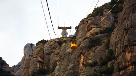 Yellow cable car in the Aeri de Montserrat rise to de Montserrat Abbey near Barcelona, Spain, Catalonia.の写真素材
