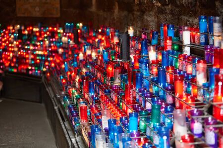 Montserrat, Spain - April 5, 2019: Many colorful candles in the Benedictine abbey Santa Maria de Montserrat in Spain.のeditorial素材