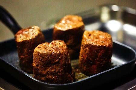 The beef steak in a frying pan. Shallow dof