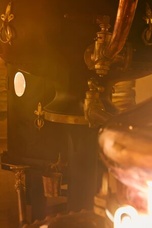 Detalis of medieval traditional distiller cube made from copper production of alcohol, cognac, whiskey. Fragment of copper old distiller for alcohol production. Ancient traditional food technologies for alcohol. Shallow dofの写真素材