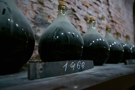 Vintage wine bottles in cellar. Shallow dof.の写真素材
