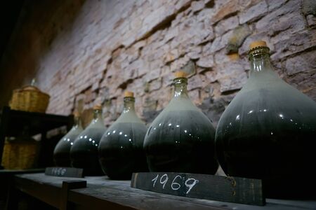 Vintage wine bottles in cellar. Shallow dof.の写真素材