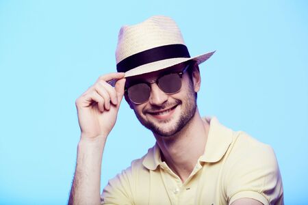 Closeup portrait of awesome hipster wearing fedora hat with intense look at camera. Headshot over...