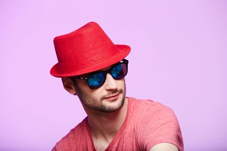 Studio shot of handsome bearded man wearing red fedora hat.の写真素材