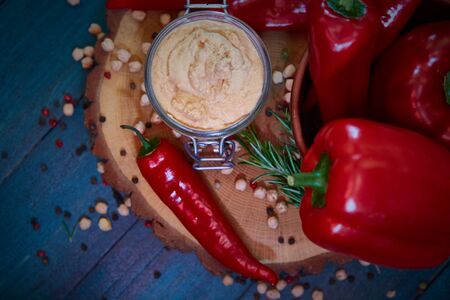 Homemade hummus with red pepper on a wood table. Selective focus and small depth of field.の写真素材