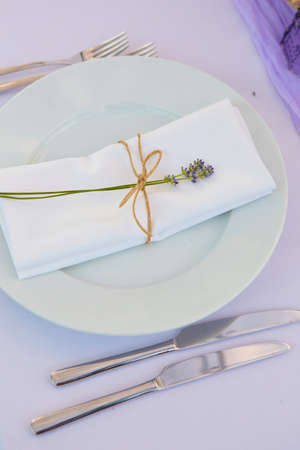 Elegant table setting for wedding engagement Easter dinner with white ceramic plates cotton napkin...