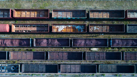 Aerial view of rail sorting freight station with railway cars, with many rail tracks railroad. Heavy...
