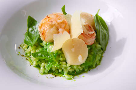 Delicious risotto with spinach, greens and prawns. Served in a modern dishware. Shallow dofの写真素材