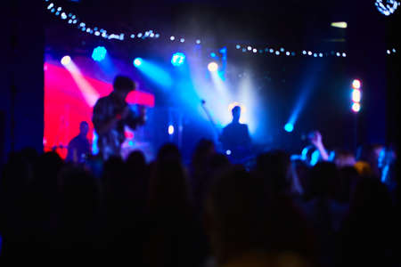 Music Concert background blur. Blurred People dancing with original bokeh lights in background - Defocused image for an artistic touch of disco club - Concept of nightlife with music and entertainmentの写真素材
