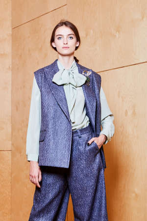 Portrait of a young woman in a blue pantsuit