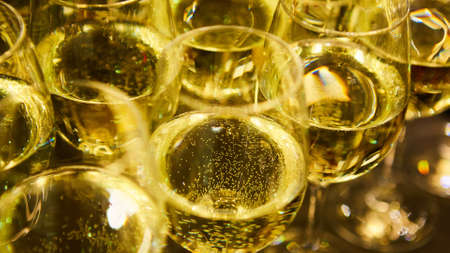 Glasses of white wine are on the table, ready to serveの写真素材