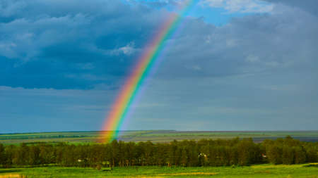 The Rainbow over Rural Landscape after Thunderstorm.の写真素材