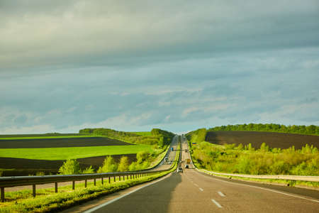 The highway traffic in sunset before the thunderstormの写真素材