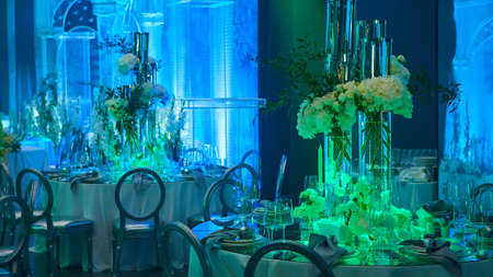 Table setup in blue light. Ready to event. Shallow dof