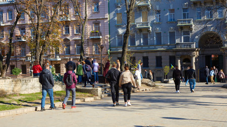 Kyiv, Ukraine - October 16, 2022: People near the funnel from the explosion of a Russian rocket on a childrens playground in the center of the capital.のeditorial素材