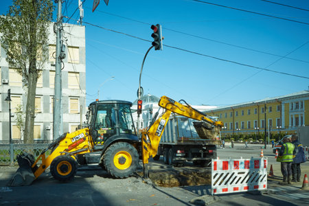 Kyiv, Ukraine - October 16, 2022: Utilities are repairing a damaged section of road nearby the...