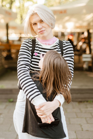 Happy young mother and little daughter are playing and fooling around outside.の写真素材