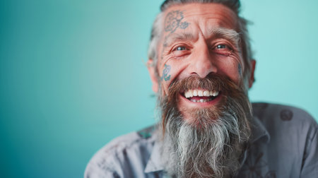 Close up portrait of happy elderly optimist man with tattoo face. Positive and cheerful at any age. Modern Agingの素材
