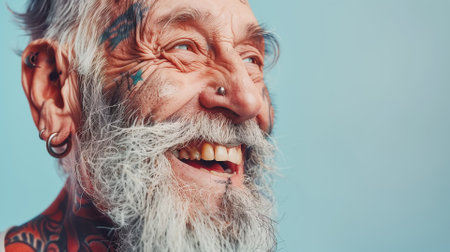 Close up portrait of happy elderly optimist man with tattoo face. Positive and cheerful at any age. Modern Agingの素材