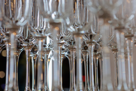 A close-up view of elegant wine glasses showcasing intricate reflections and crystal-clear details....