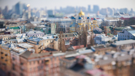 Unique tilt-shift perspective of a vibrant city street scene with historic European architecture and traffic, creating a captivating miniature effect. Ideal for projects related to urban life, travel, unique photography, or architectureの写真素材