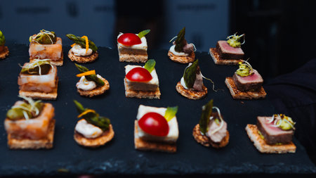 Gourmet appetizers on a slate tray. Concept for luxury catering, fine dining, and sophisticated...