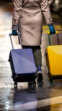 A chic traveler with two suitcases. Symbolizes the modern journey, work-life balance, choices, and moving forward.の写真素材