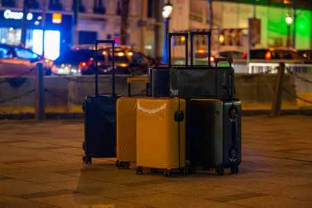 A collection of luggage on a city street. Concept for group travel, family vacations, and the modern journey.の写真素材