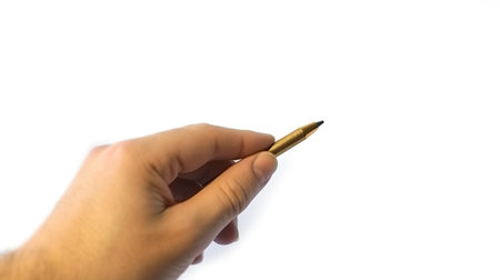Hand holding pen to write letter or signature. AI generated imageの素材
