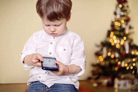 Boy playing with mobile phone