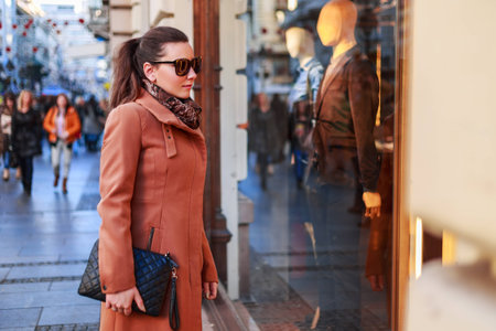 Girl looking at show-windowの写真素材