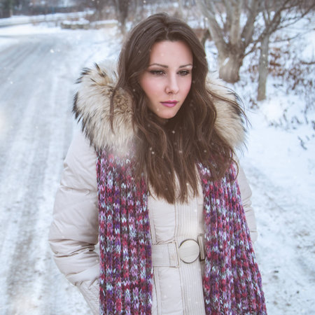 Sad girl in snowの写真素材