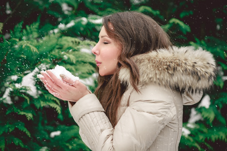 Girl blowing snow to the sideの写真素材