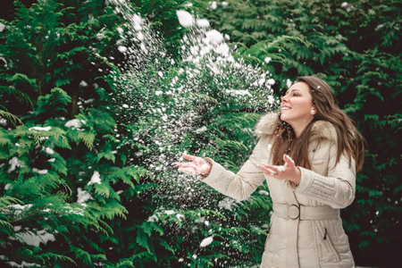 Girl throwing snowの写真素材