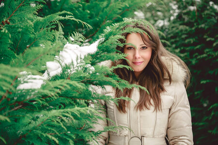 Girl looking trough tree branchの写真素材