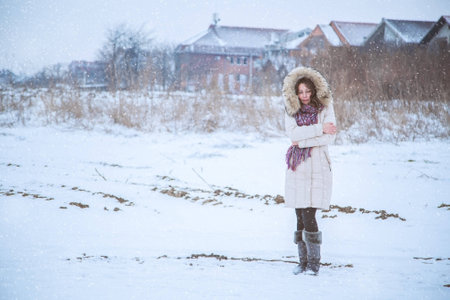 Girl is feeling cold in snowの写真素材