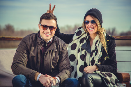 Girl holding bunny ears to her boyfriendの写真素材