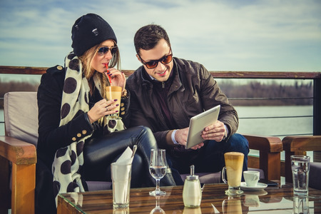 Man and woman loking at tabletの写真素材