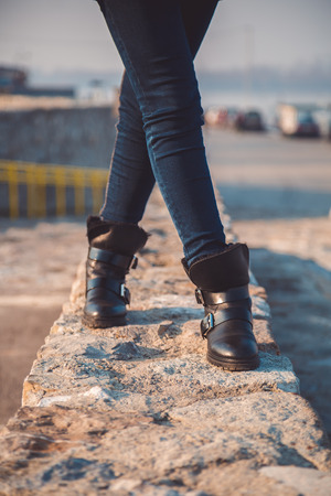Girl walking on narrow wallの写真素材