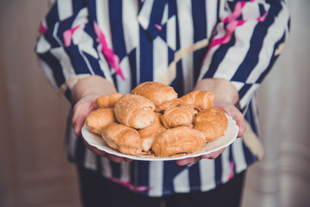Old hands holding plate with crossansの写真素材