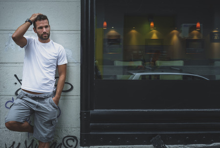 Handsome man posing on a wallの写真素材